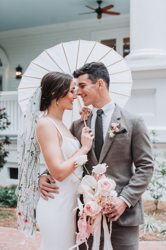 Bride and groom touch foreheads and smile