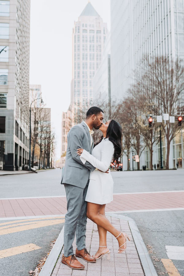 girl and guy kiss in the street of Atlanta Midtown