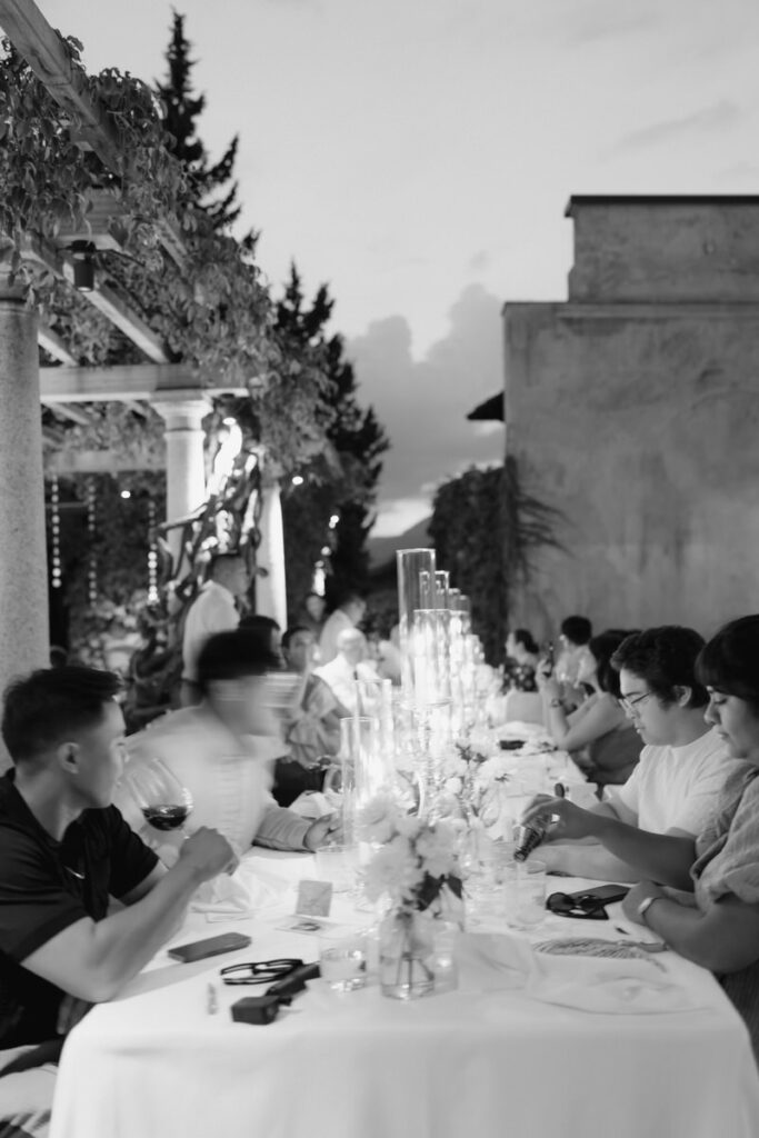 Guests interact at a table during wedding reception at Villa cimbrone wedding venue